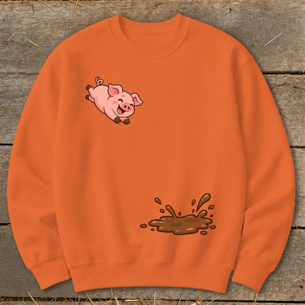 Orange sweatshirt with a cartoon pig jumping through a mud puddle.