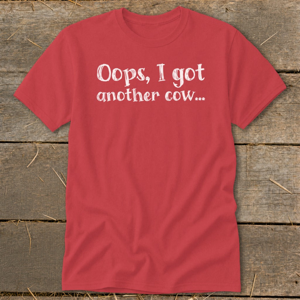 Red t-shirt with white text reading "Oops, I got another cow...".