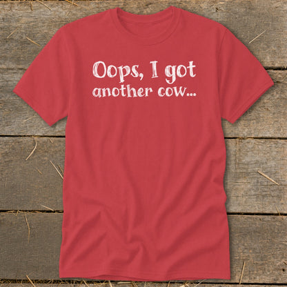 Red t-shirt with white text reading "Oops, I got another cow...".