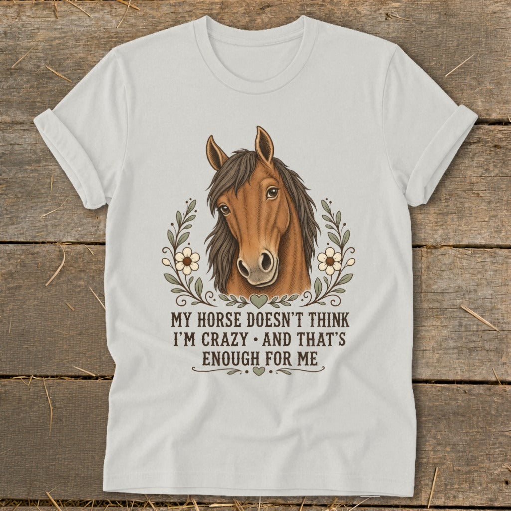 White t-shirt with a horse illustration and the text "MY HORSE DOESN'T THINK I'M CRAZY • AND THAT'S ENOUGH FOR ME".