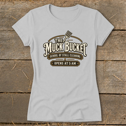 Gray t-shirt with "The Muck Bucket School of Stall Cleaning Opens At 5 AM" logo.
