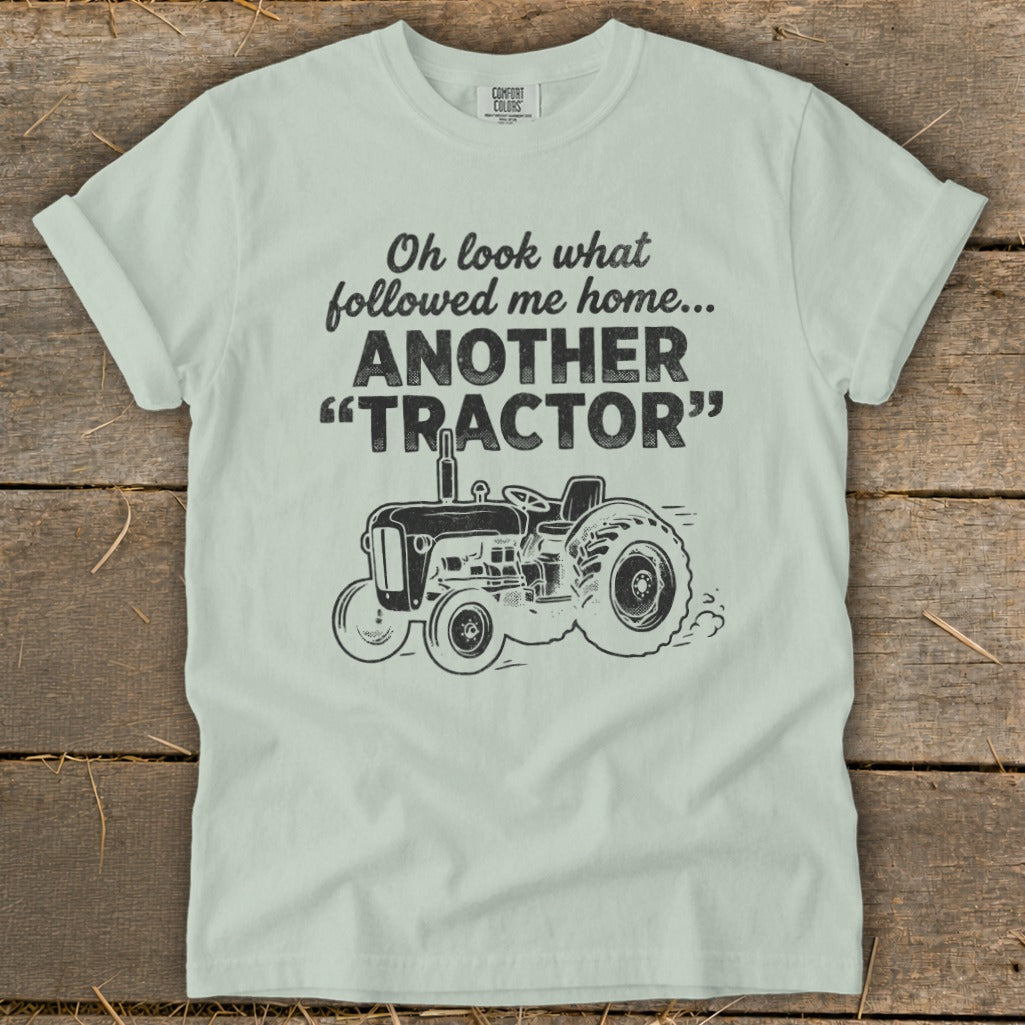 Light green t-shirt with "Oh look what followed me home... ANOTHER 'TRACTOR'" and tractor graphic.