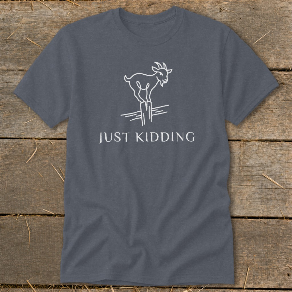 Gray t-shirt with a white outline of a goat balancing on a fence, with text "JUST KIDDING".