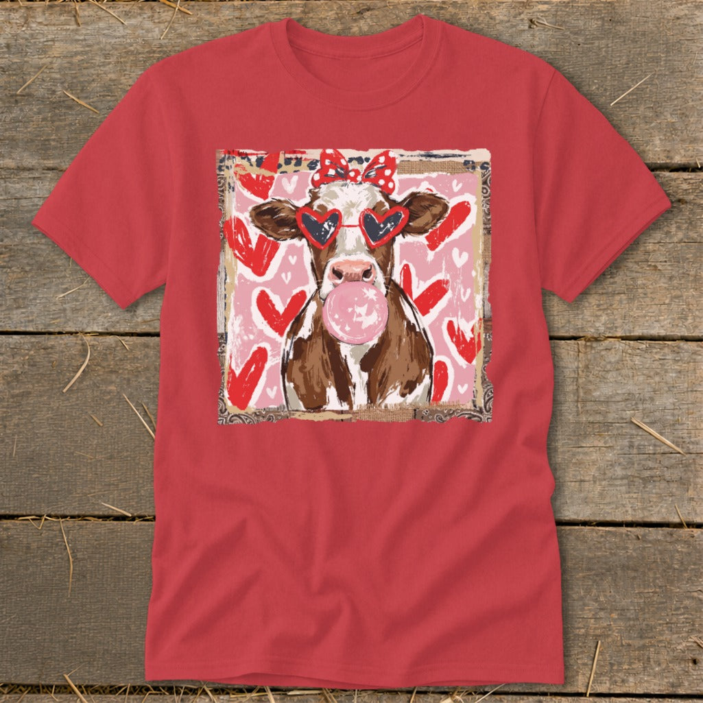 Red t-shirt with a cow wearing heart sunglasses blowing bubblegum.