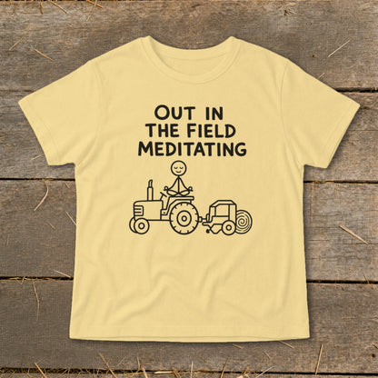 Yellow t-shirt with black text and illustration of stick figure meditating on a tractor.