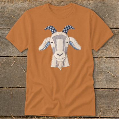 Orange t-shirt with a stitched applique of a goat's face featuring blue plaid horns.