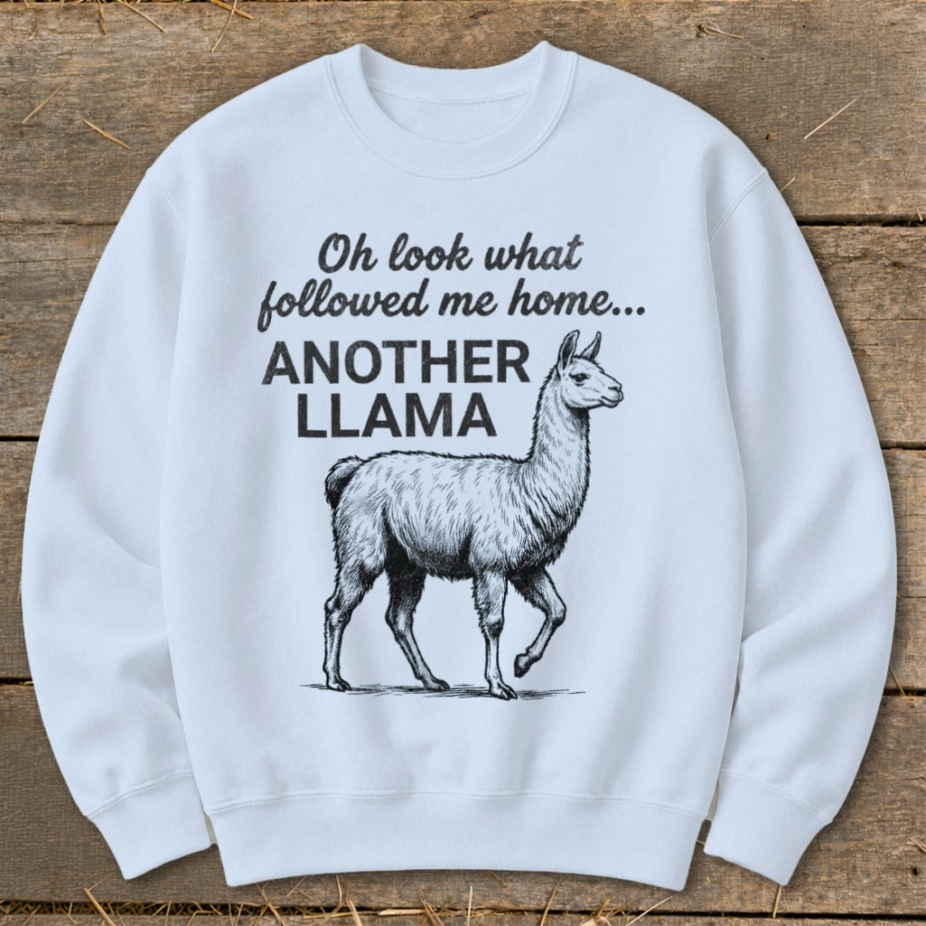 White sweatshirt with text "Oh look what followed me home... ANOTHER LLAMA" and a llama illustration.