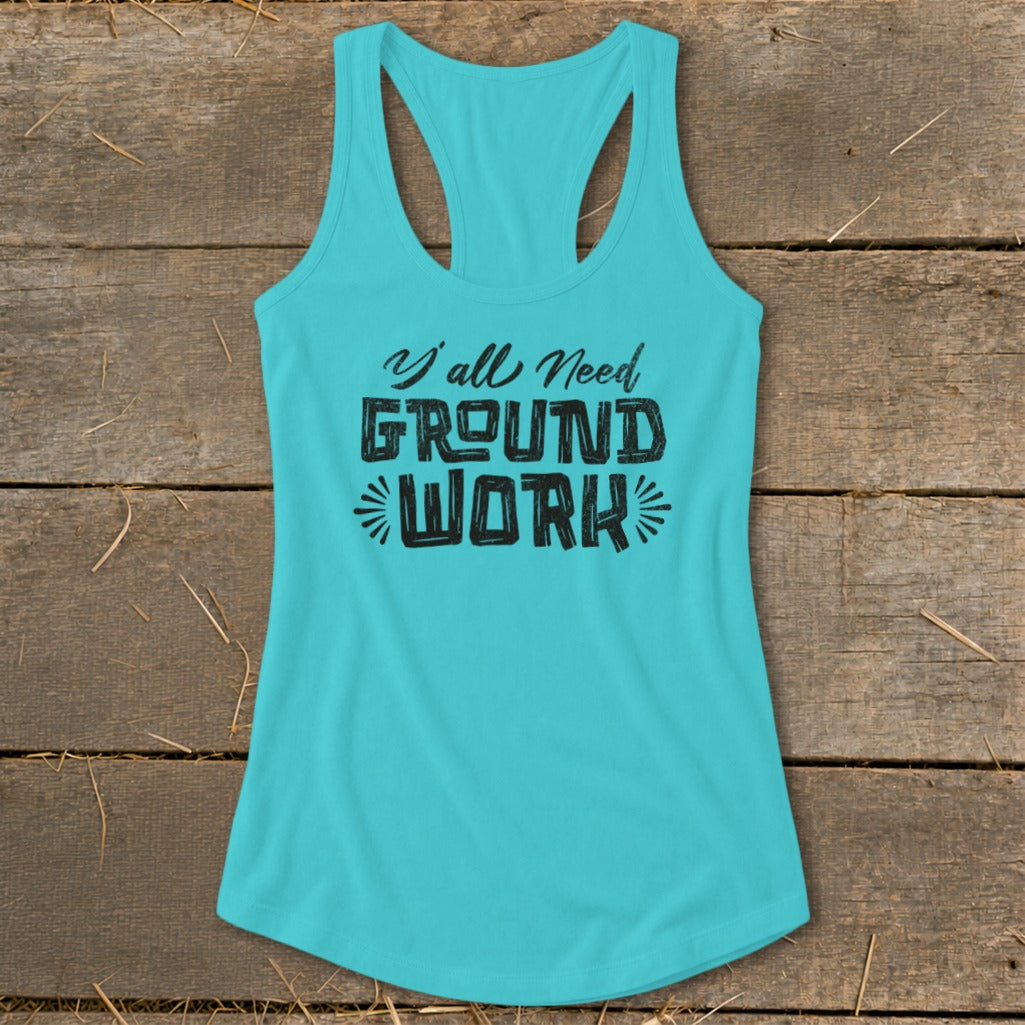 Teal racerback tank top with black text reading "Y'all Need GROUND WORK".