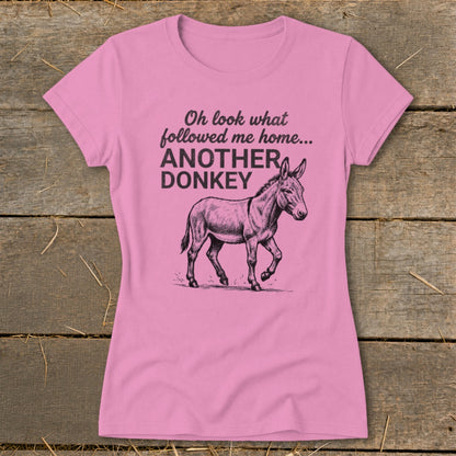 Pink t-shirt with text "Oh look what followed me home... ANOTHER DONKEY" and a donkey illustration.