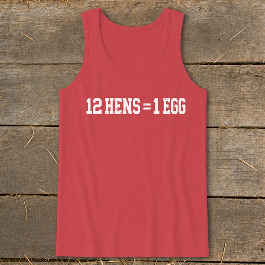 A red tank top printed with the white text 12 HENS = 1 EGG on a rustic wooden background.