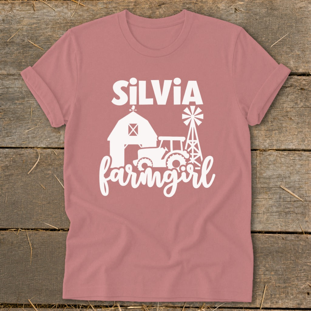 Pink t-shirt with "SiLViA farmgirl" and farm graphics in white.