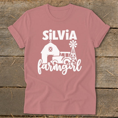 Pink t-shirt with "SiLViA farmgirl" and farm graphics in white.