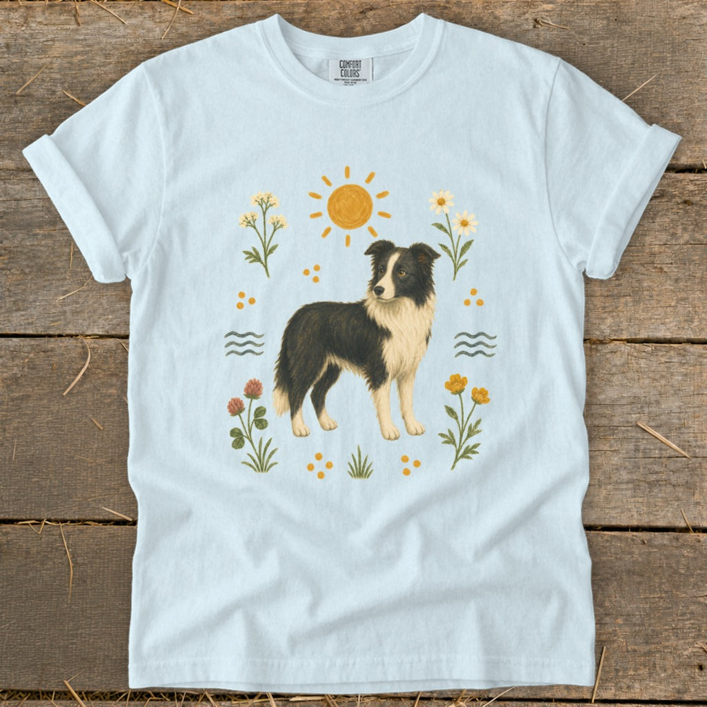 Light blue t-shirt with a Border Collie illustration, sun, and flowers.