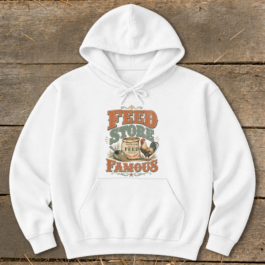 White hoodie with "Feed Store Famous" graphic featuring a rooster and bag of feed.