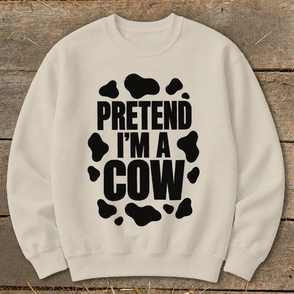 Cream sweatshirt with black text "PRETEND I'M A COW" and cow spots.