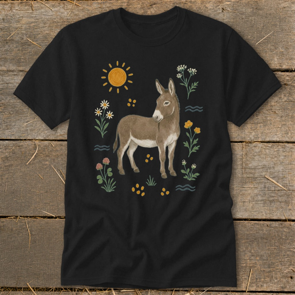Black t-shirt with a brown donkey illustration and colorful flowers, sun, and yellow dots.