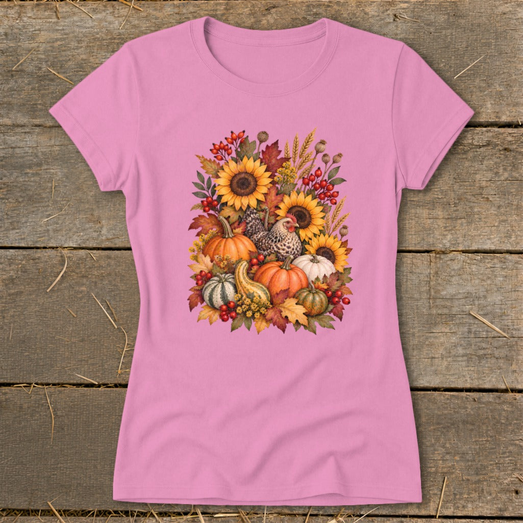 Pink t-shirt with a fall harvest graphic featuring pumpkins, sunflowers, and chickens.