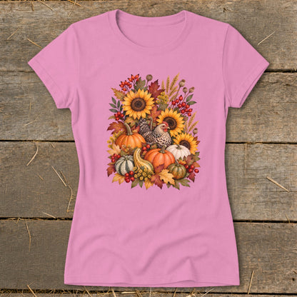 Pink t-shirt with a fall harvest graphic featuring pumpkins, sunflowers, and chickens.