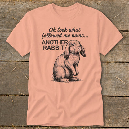 Peach t-shirt with drawing of a rabbit and text "Oh look what followed me home... ANOTHER RABBIT"
