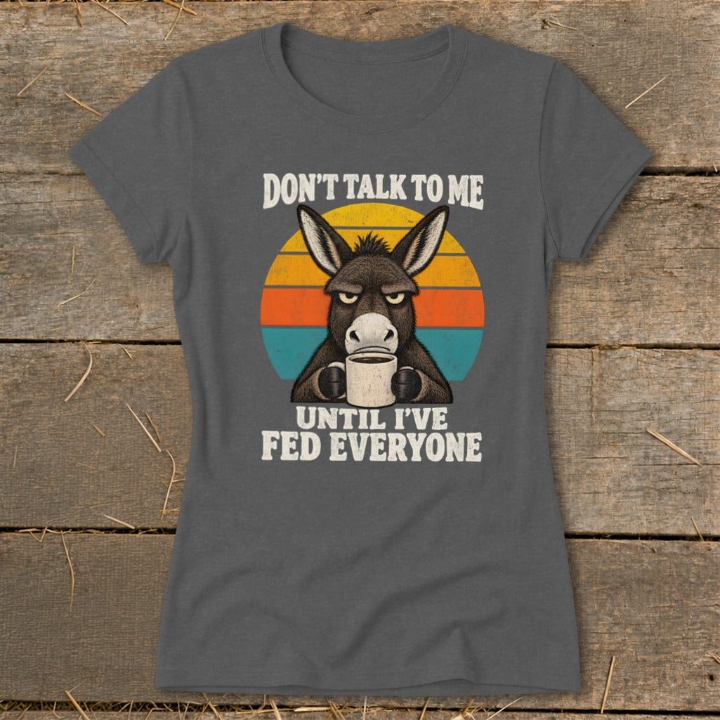 Charcoal grey t-shirt featuring an angry donkey drinking coffee and text reading Don't talk to me until I've fed everyone.