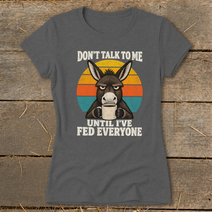 Charcoal grey t-shirt featuring an angry donkey drinking coffee and text reading Don't talk to me until I've fed everyone.