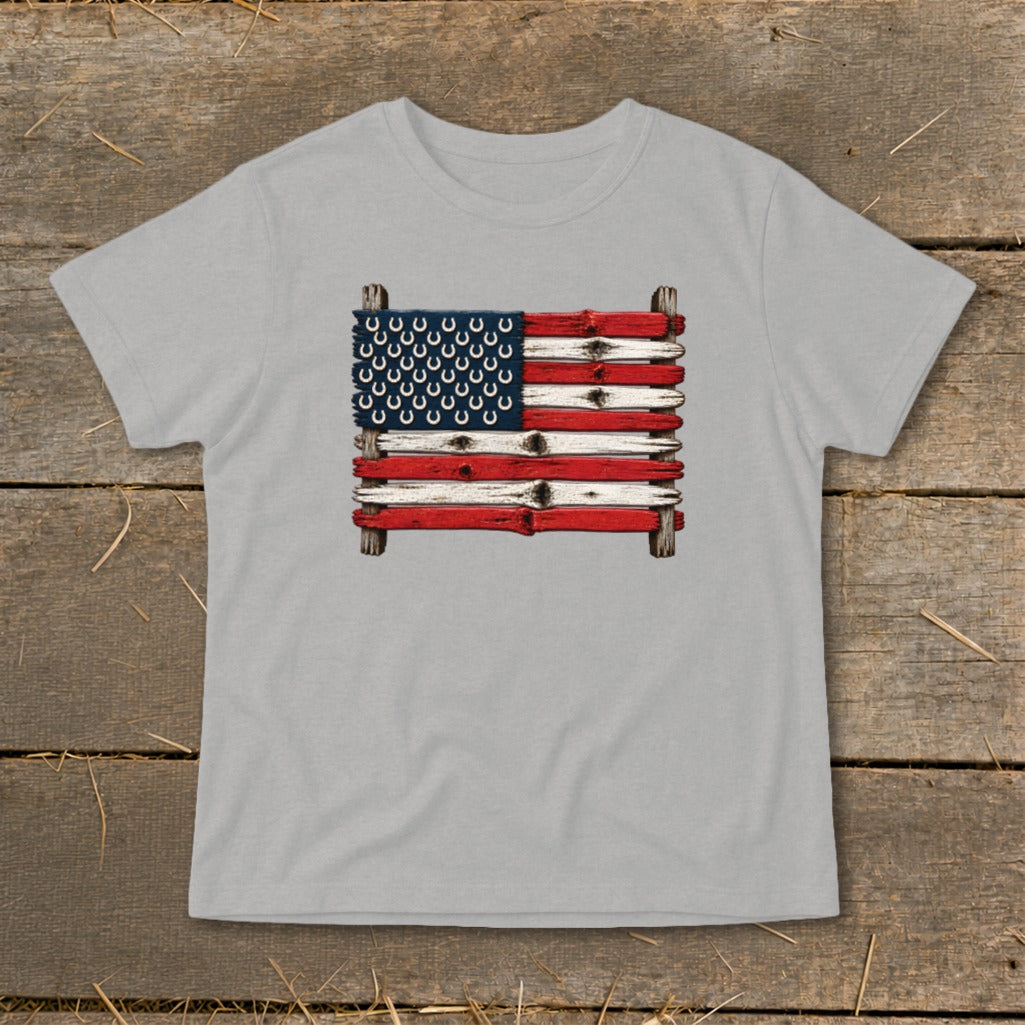 A light gray t-shirt featuring a rustic American flag made of painted wooden planks with horseshoe stars.