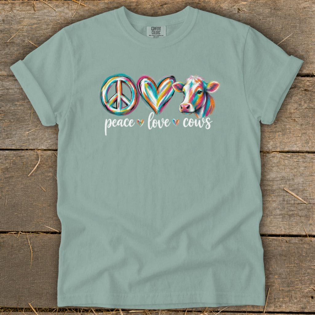T-shirt with peace sign, heart, and cow graphic with text "peace love cows".
