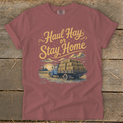 Truck loaded with hay bales and text "Haul Hay or Stay Home".