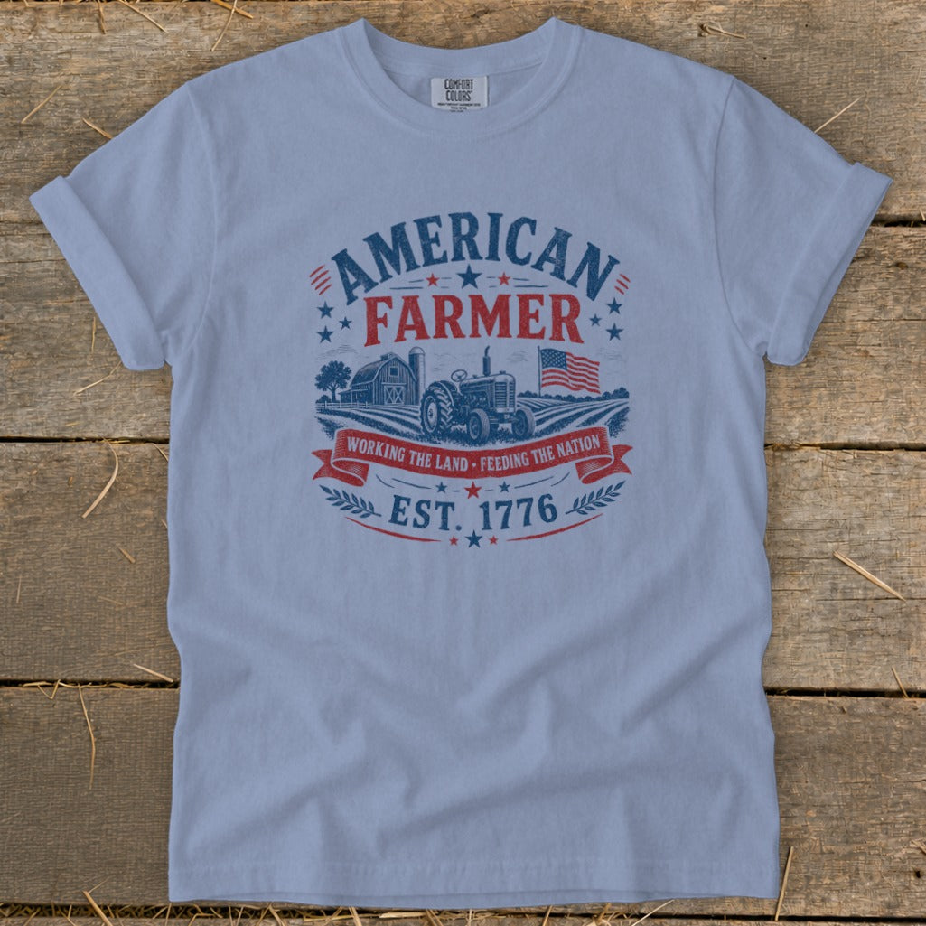 Light blue t-shirt with "American Farmer", tractor, barn, and American flag graphic.