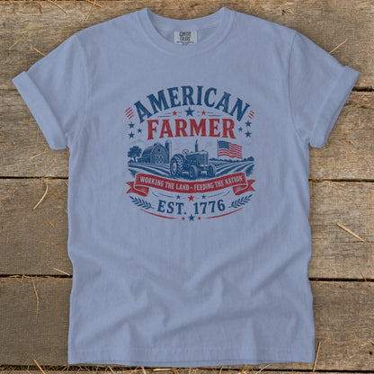 Light blue t-shirt with "American Farmer", tractor, barn, and American flag graphic.