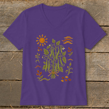 Purple v-neck t-shirt with a vintage-style illustration of pea pods and gardening elements.