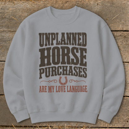 Light grey sweatshirt with text: "UNPLANNED HORSE PURCHASES ARE MY LOVE LANGUAGE"