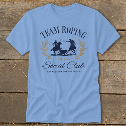 Light blue t-shirt with "Team Roping Social Club" graphic and equestrian illustration.