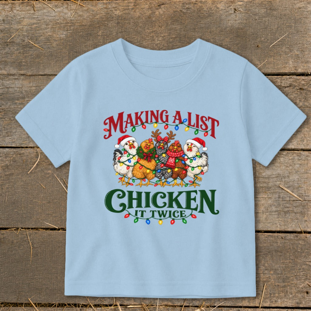 Light blue t-shirt with chickens wearing Santa hats and Christmas lights, text "MAKING A LIST CHICKEN IT TWICE".