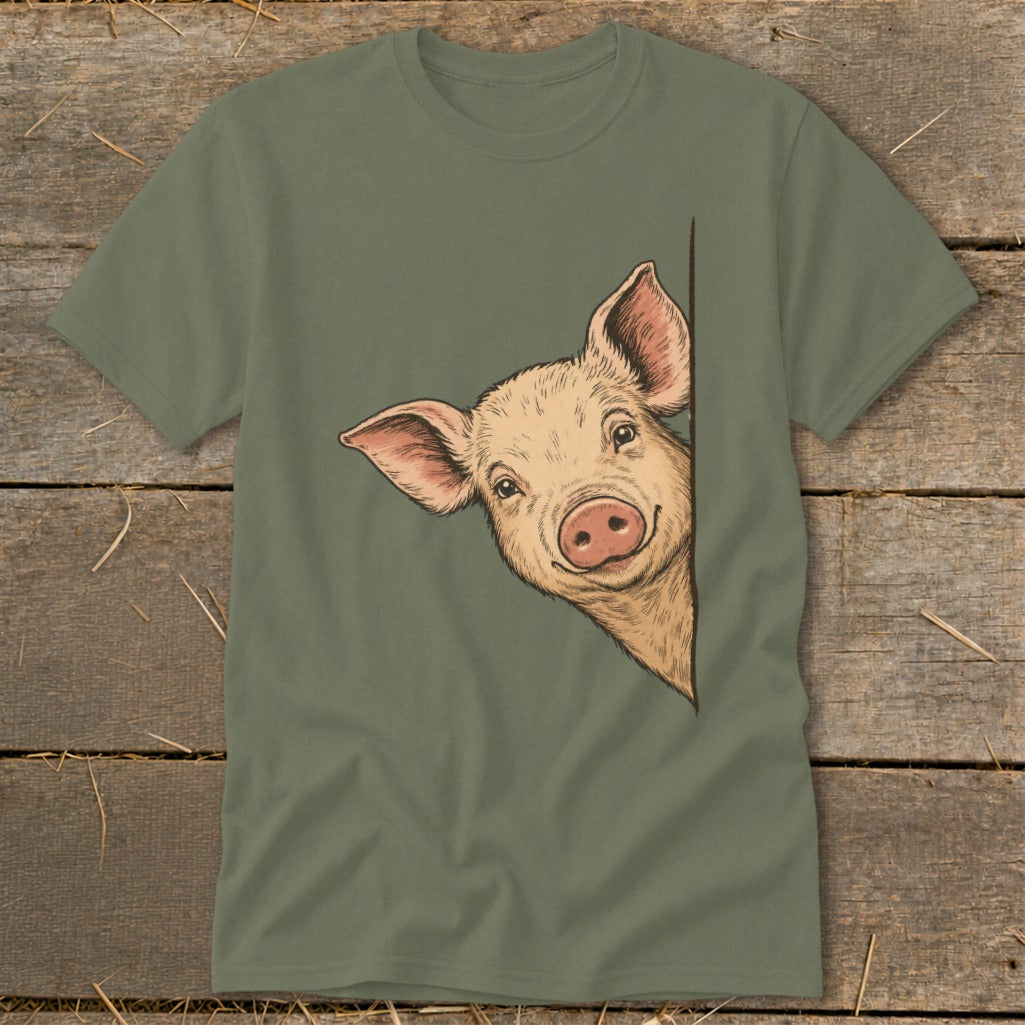 Green t-shirt with a sketch of a smiling pig peeking from the side.