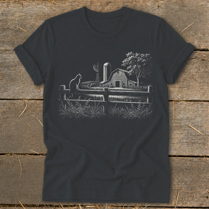 Dark t-shirt with white line art of a cat on a fence, barn, and windmill.