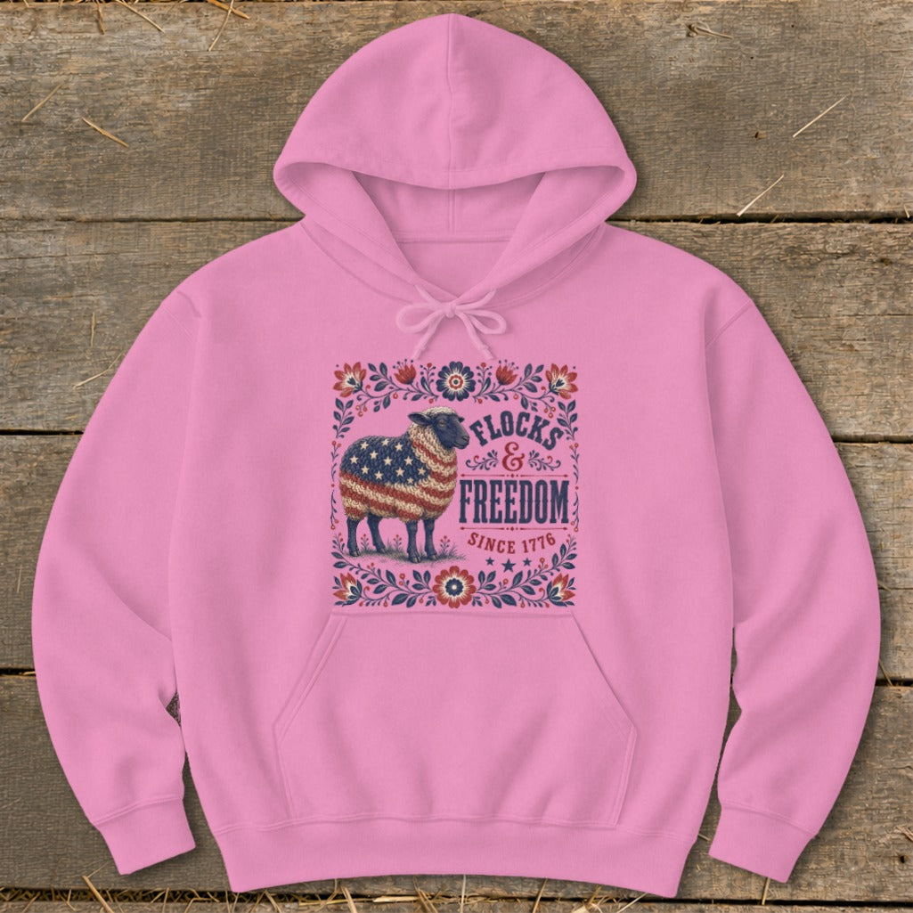 Pink hoodie with sheep graphic "Flocks & Freedom Since 1776".