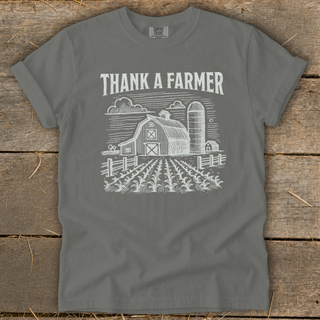 Gray t-shirt with "Thank a Farmer" text and a farm sketch.