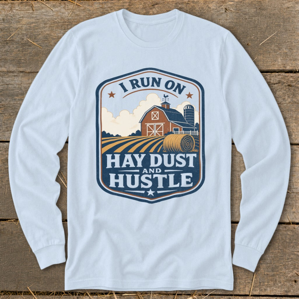 Long sleeve shirt with a farm scene and text: "I Run On Hay Dust And Hustle."