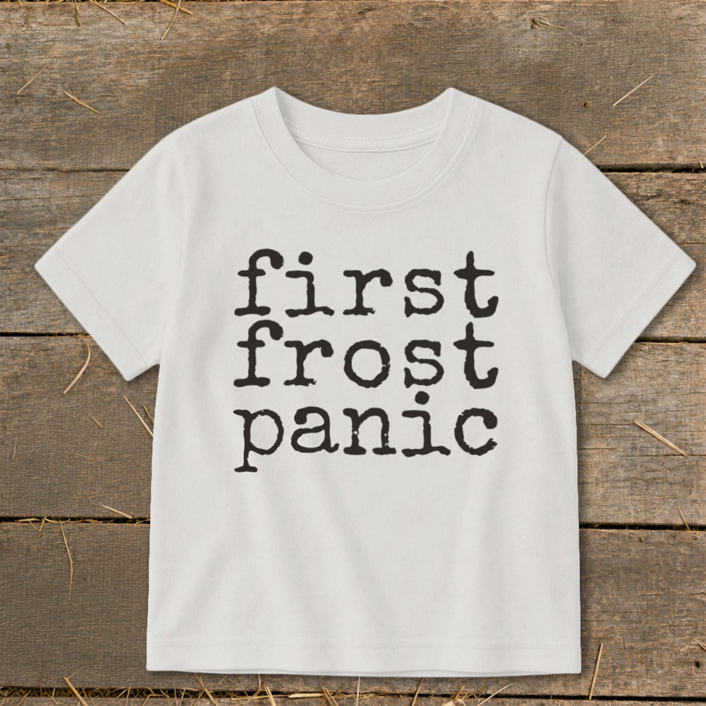 White t-shirt with "first frost panic" text in black typewriter font.