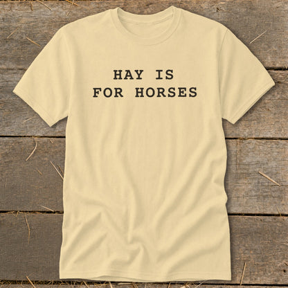 Light yellow t-shirt with black text reading "HAY IS FOR HORSES".