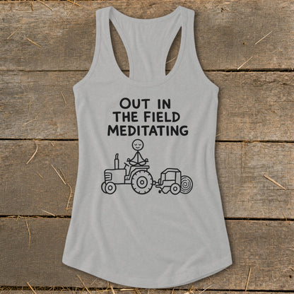 Gray tank top with text "OUT IN THE FIELD MEDITATING" and cartoon tractor.