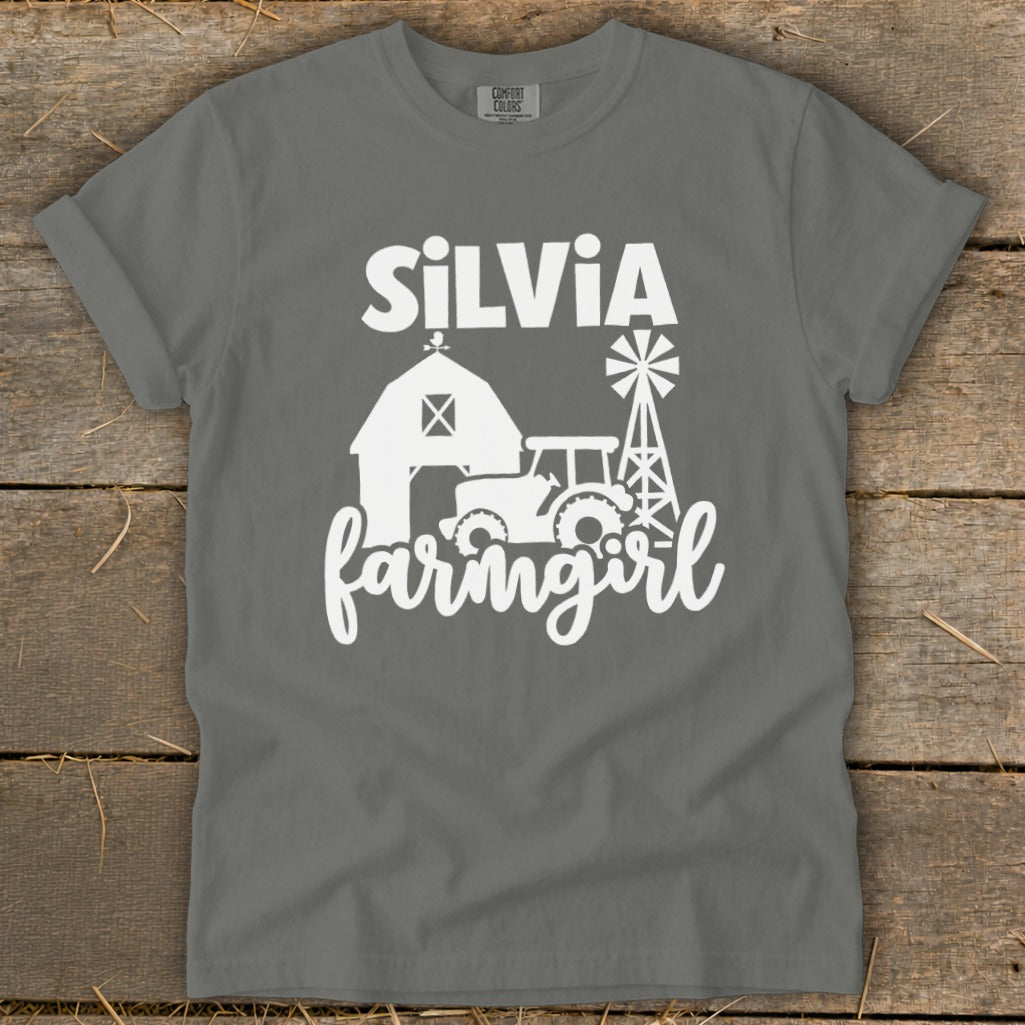 Gray t-shirt with white text "Silvia Farmgirl" and farm graphics.