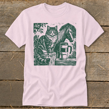 Green linocut of a cat and horse with a mug next to a barn.