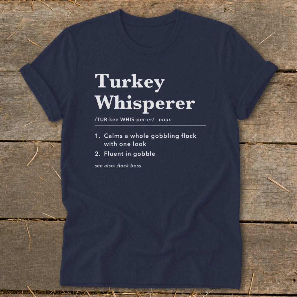 Navy t-shirt with "Turkey Whisperer" definition including pronunciation and humorous descriptions.