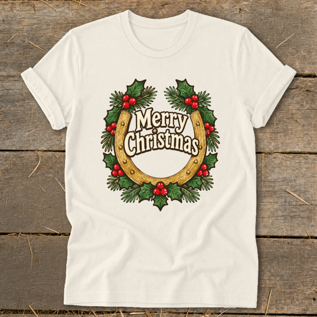Cream t-shirt with a horseshoe and holly wreath graphic that says "Merry Christmas".