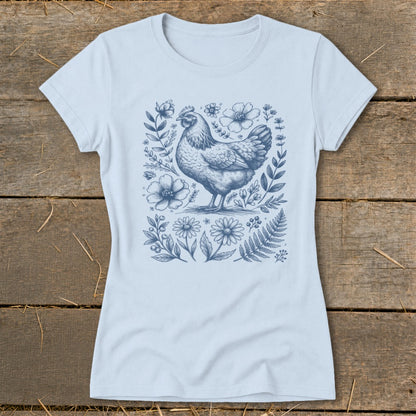 Light blue t-shirt with a blue ink drawing of a chicken surrounded by flowers and foliage.