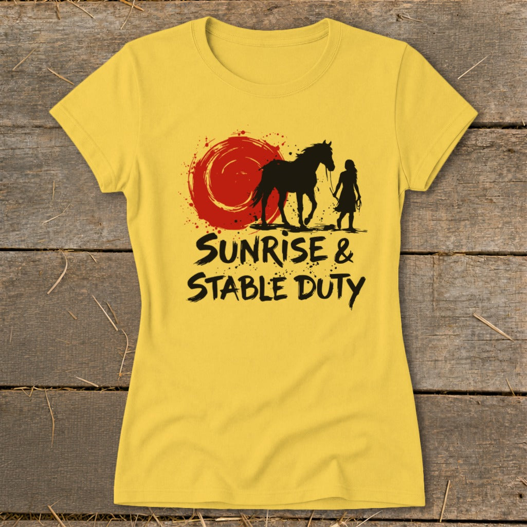 Yellow t-shirt with black graphic of a horse, woman, and sun, with text "SUNRISE & STABLE DUTY".