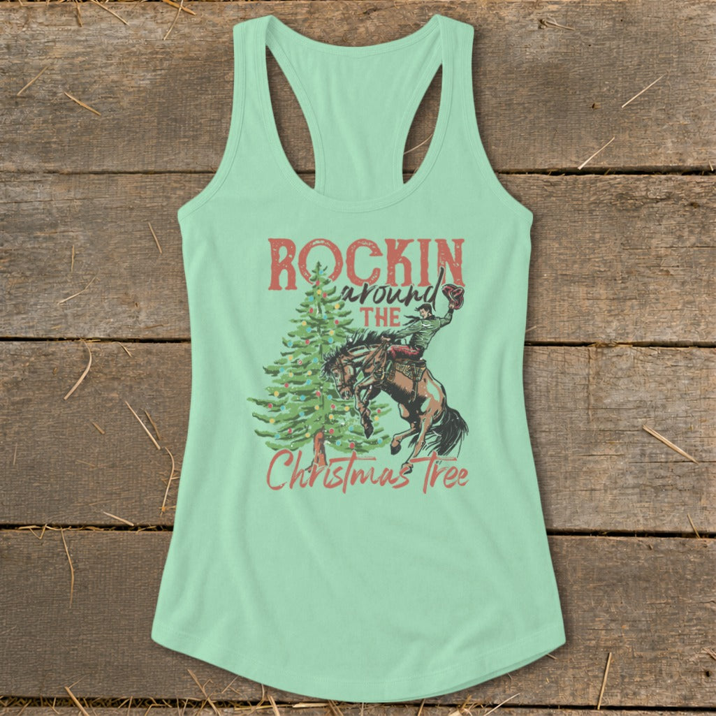 Mint tank top with a cowboy on a bucking horse and Christmas tree graphic.