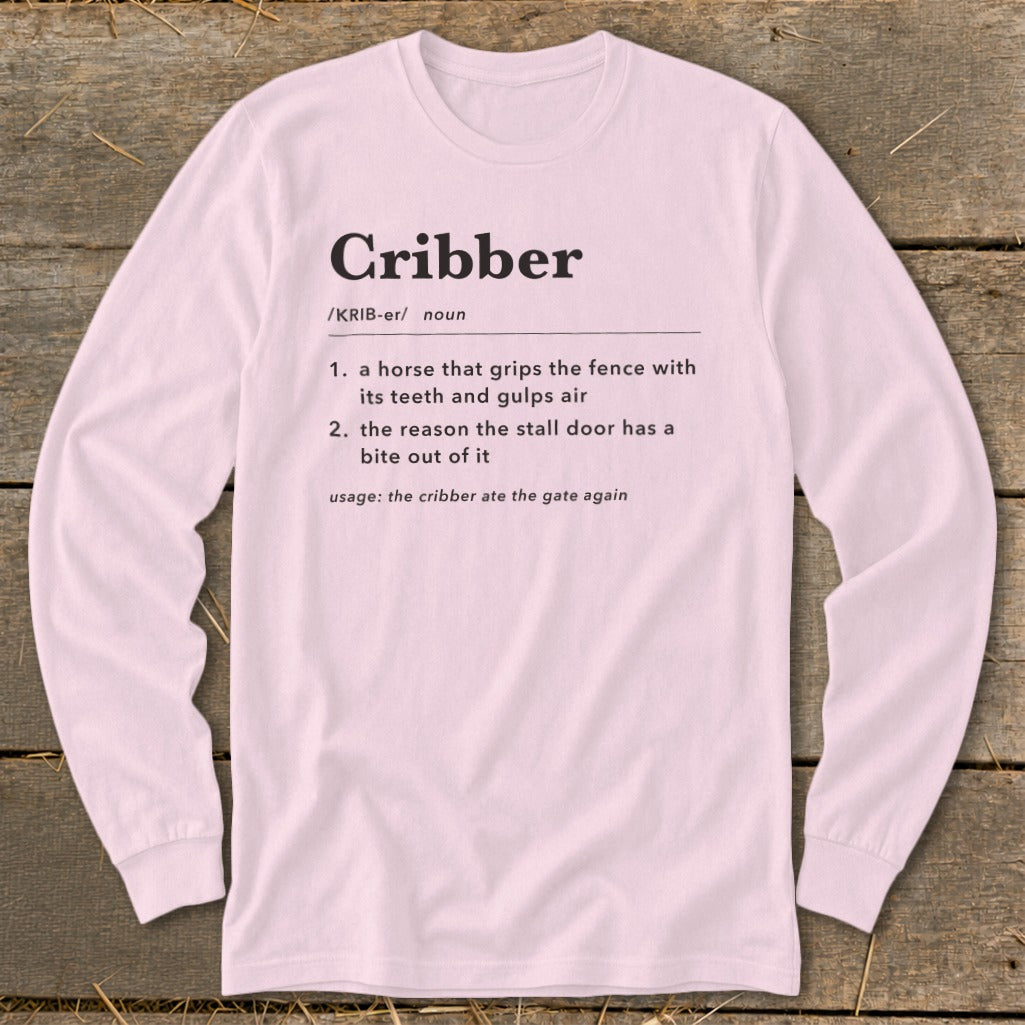 Light pink long-sleeve t-shirt with a humorous dictionary definition of the word cribber printed on the chest.